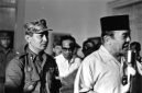 INDONESIA - MARCH 11:  President Sukarno (R) of Indonesia walks with the Major General Suharto (L) March 11, 1966 in Idonesia. Sukarno, was obliged (ordered) by the Indonesia Army to give Major General Suharto Supreme Authority to restore order after the Sept. 30, 1965 murders of six Generals, Army Chief Nation's bodyguard and daughter, accused by the army of being led by the Indonesia Communist Party, (the PKI). General Suharto, not of high enough rank to be on the hit list, took over leadership of the army. Between October 1965 and March 1966, under Suharto's command, thousands of suspected and known communists were killed and imprisoned throughout Indonesia.   In March 1976, the Indonesian Parliament (The People's General Assembly) stripped President Sukarno of all powers and appointed General Suharto as Acting President.  Sukarno was placed under house arrest until his death in June, 1970.  (Photo by Beryl Bernay/Getty Images)