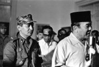 INDONESIA - MARCH 11: President Sukarno (R) of Indonesia walks with the Major General Suharto (L) March 11, 1966 in Idonesia. Sukarno, was obliged (ordered) by the Indonesia Army to give Major General Suharto Supreme Authority to restore order after the Sept. 30, 1965 murders of six Generals, Army Chief Nation's bodyguard and daughter, accused by the army of being led by the Indonesia Communist Party, (the PKI). General Suharto, not of high enough rank to be on the hit list, took over leadership of the army. Between October 1965 and March 1966, under Suharto's command, thousands of suspected and known communists were killed and imprisoned throughout Indonesia. In March 1976, the Indonesian Parliament (The People's General Assembly) stripped President Sukarno of all powers and appointed General Suharto as Acting President. Sukarno was placed under house arrest until his death in June, 1970. (Photo by Beryl Bernay/Getty Images)