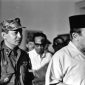 INDONESIA - MARCH 11:  President Sukarno (R) of Indonesia walks with the Major General Suharto (L) March 11, 1966 in Idonesia. Sukarno, was obliged (ordered) by the Indonesia Army to give Major General Suharto Supreme Authority to restore order after the Sept. 30, 1965 murders of six Generals, Army Chief Nation's bodyguard and daughter, accused by the army of being led by the Indonesia Communist Party, (the PKI). General Suharto, not of high enough rank to be on the hit list, took over leadership of the army. Between October 1965 and March 1966, under Suharto's command, thousands of suspected and known communists were killed and imprisoned throughout Indonesia.   In March 1976, the Indonesian Parliament (The People's General Assembly) stripped President Sukarno of all powers and appointed General Suharto as Acting President.  Sukarno was placed under house arrest until his death in June, 1970.  (Photo by Beryl Bernay/Getty Images)